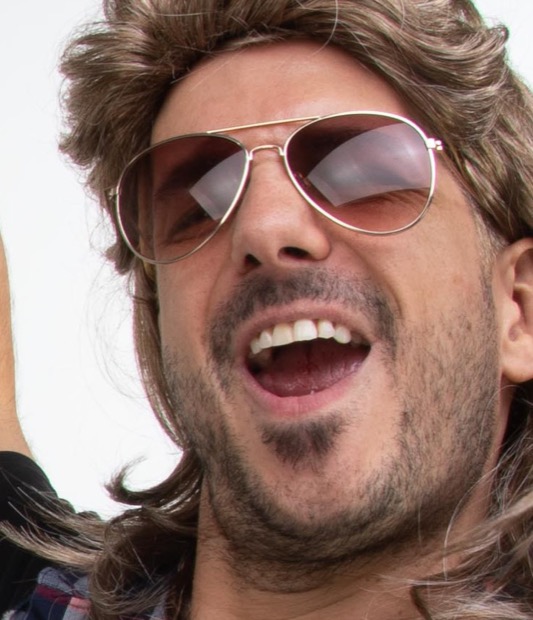 Codey mid-yell, blond mullet, aviators