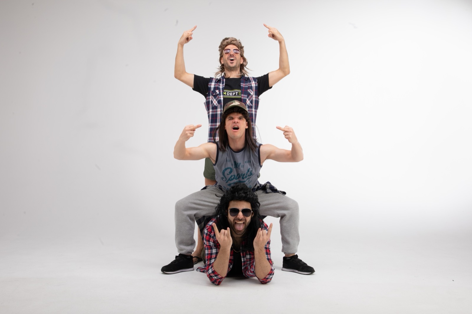 The three blokes stacked in a human pyramid, mullets and all